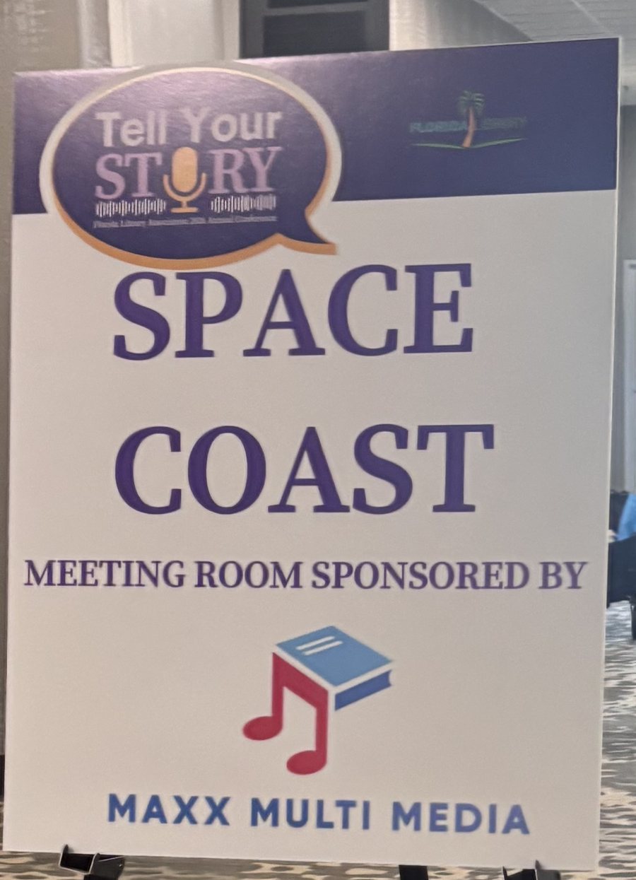 Easel sign at the Florida Library Association annual conference reading Space Coast meeting room sponsored by MaxX Multi Media.